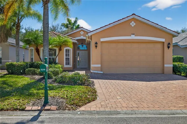 Mediterranean / spanish home featuring an attached garage, stucco siding, decorative driveway, and a tile roof