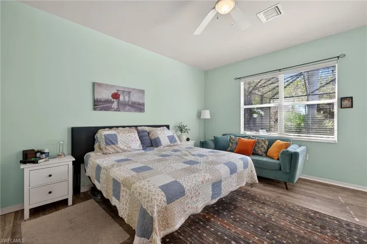 Primary bedroom featuring dark wood finished floors and ceiling fan
