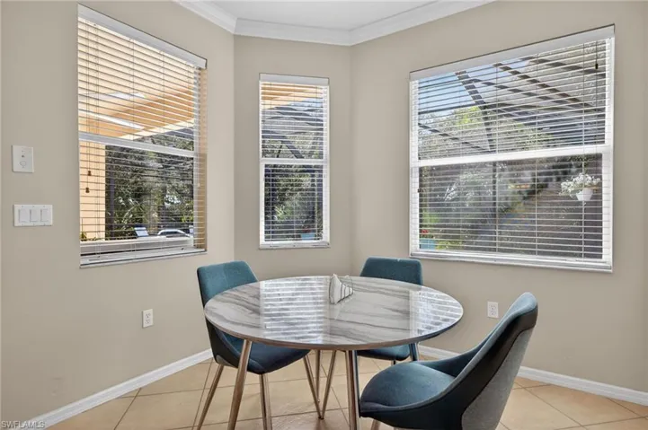 Dining space featuring crown molding and light tile patterned floors