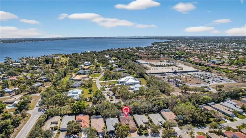 Aerial perspective of suburban area featuring a nearby body of water