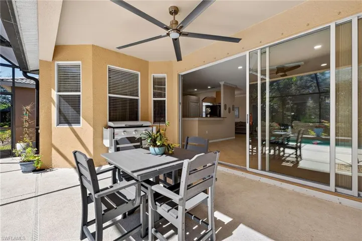 View of patio with outdoor dining area, a ceiling fan, a grill, a lanai, and a sunroom