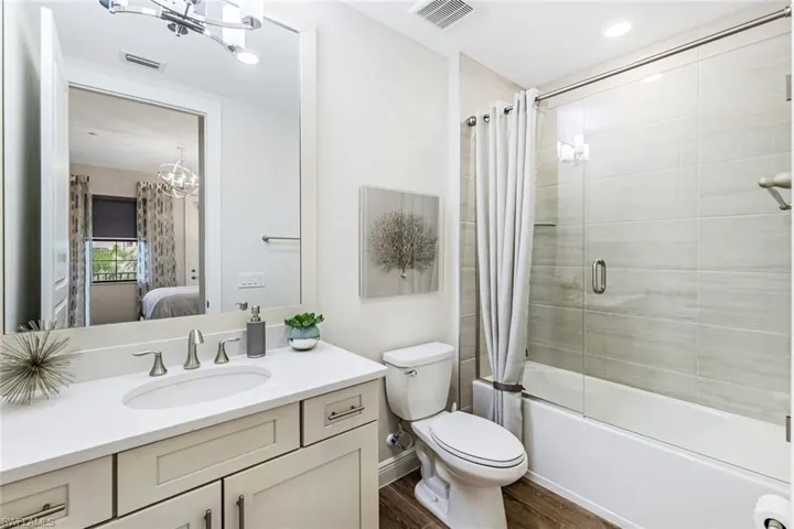 Adjoining bath to the second guest suite featuring shower over tub