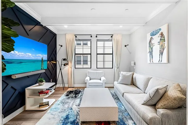 Spacious den tucked behind pocket doors with tile flooring, feature wall