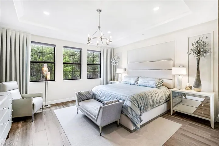 Primary bedroom with private preserve view, tile flooring