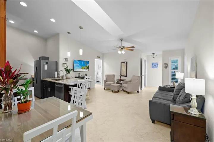 Living room featuring ceiling fan and sink