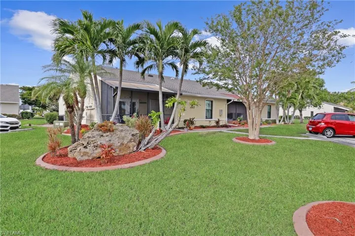 View of front of property featuring a sunroom and a front yard