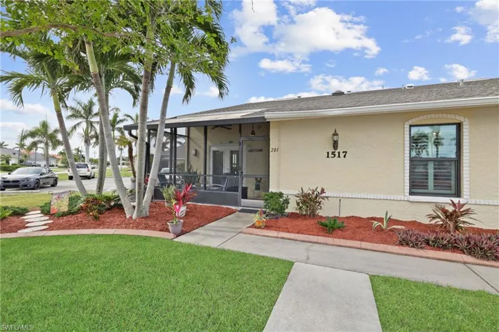 View of exterior entry with a yard