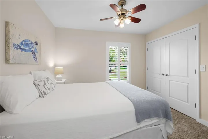 Bedroom featuring carpet, ceiling fan, and a closet