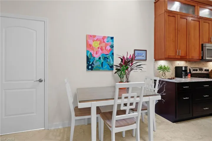 Kitchen with backsplash and light tile patterned flooring