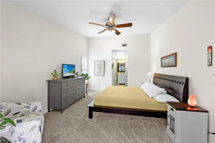 Carpeted bedroom with ceiling fan