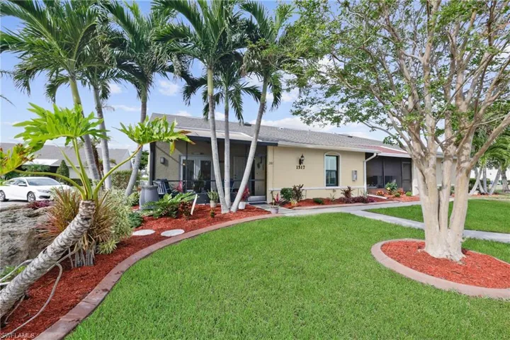 Ranch-style home with a sunroom and a front lawn