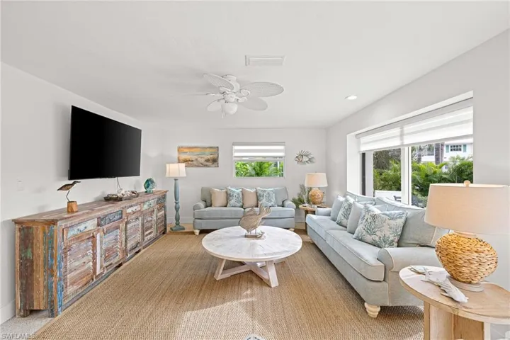 Living area featuring healthy amount of natural light and a ceiling fan