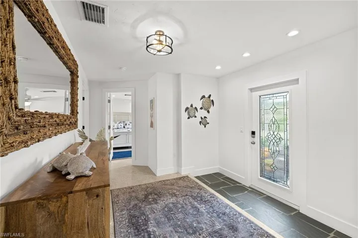 Entryway with baseboards and recessed lighting