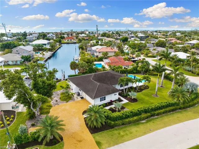 Aerial view of residential area featuring a large body of water