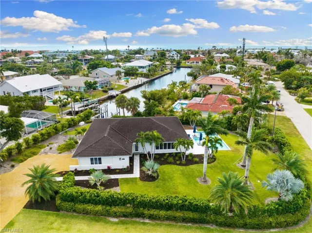 Aerial view of residential area featuring a nearby body of water