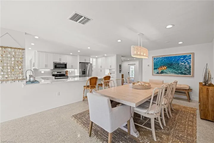 Dining area with recessed lighting and dark speckled floor