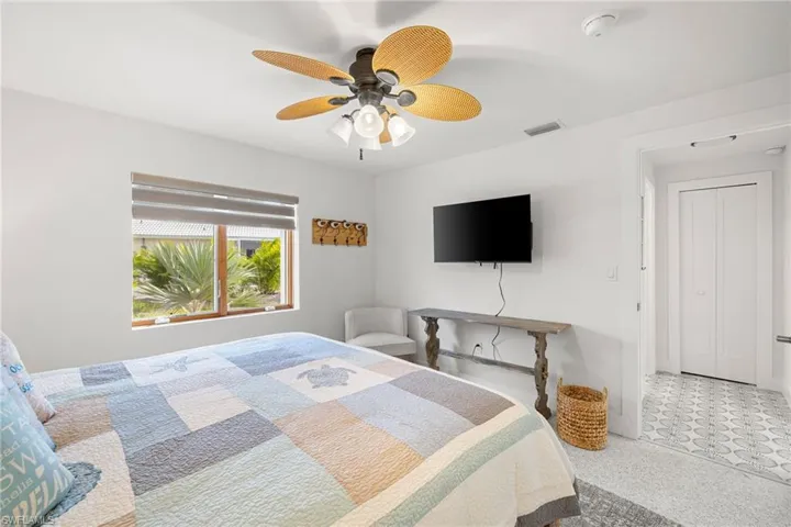 Bedroom featuring ceiling fan and tile patterned floors