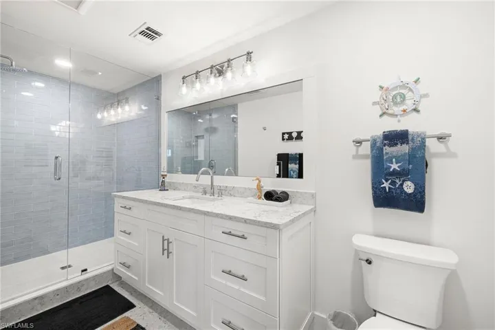 Full bath with vanity and a shower stall