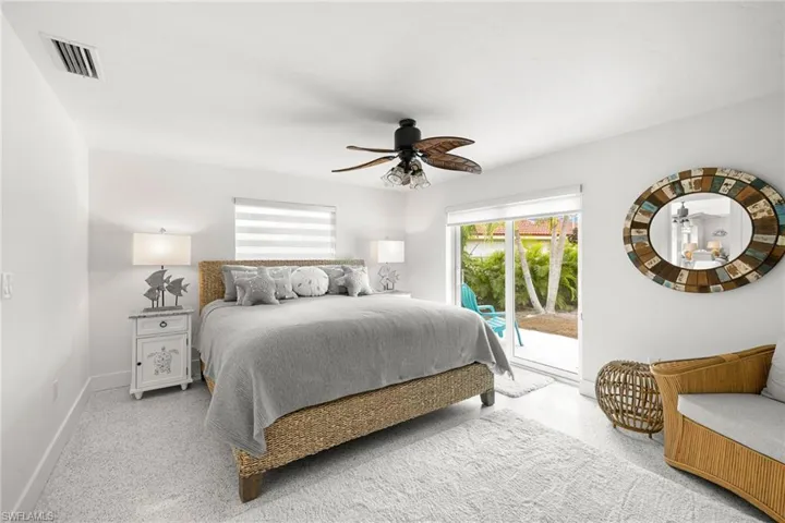 Bedroom with access to outside and a ceiling fan