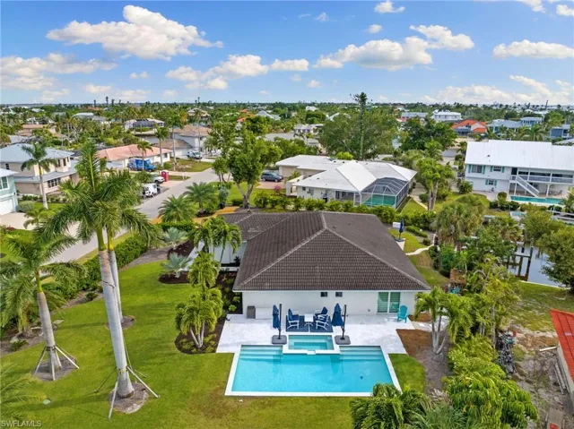 Aerial view of residential area featuring a pool