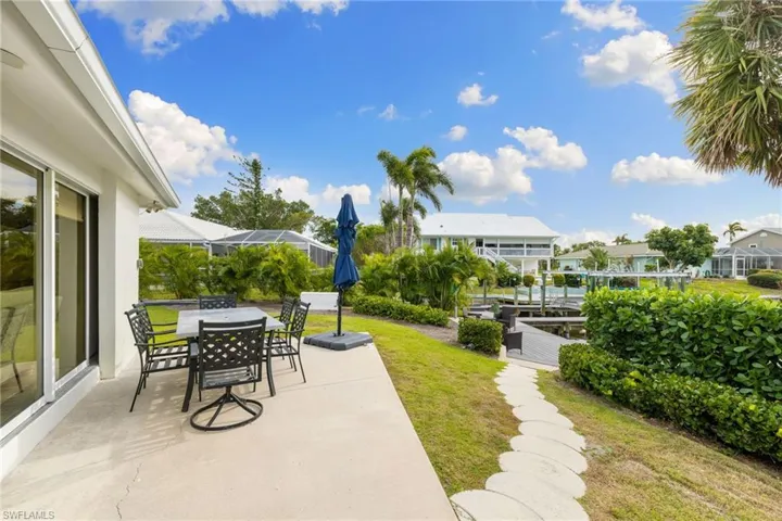 View of patio / terrace with a residential view, a lanai, and outdoor dining space