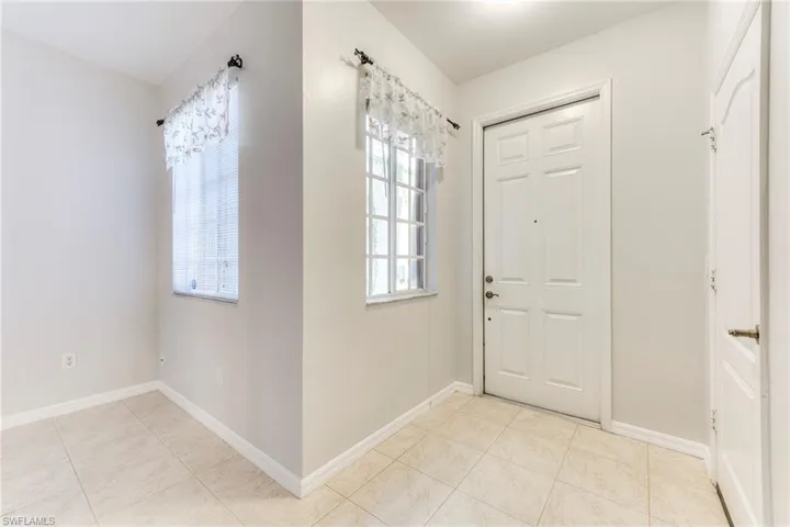 Entryway with light tile patterned floors