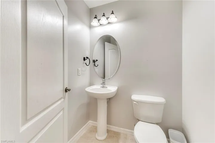 Half bath featuring toilet and tile patterned flooring