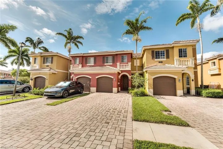 Mediterranean / spanish-style home featuring a garage, decorative driveway, stucco siding, and a tile roof