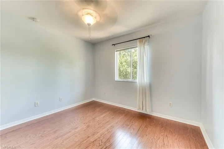 Bedroom with wood finished floors and a ceiling fan
