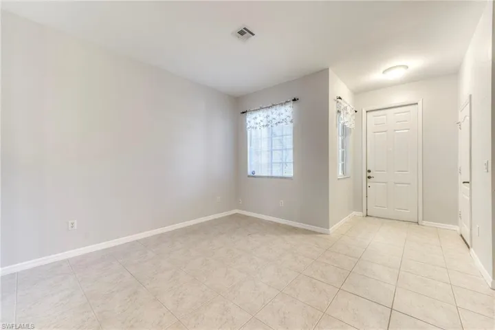 Foyer entrance featuring baseboards and light tile patterned floors