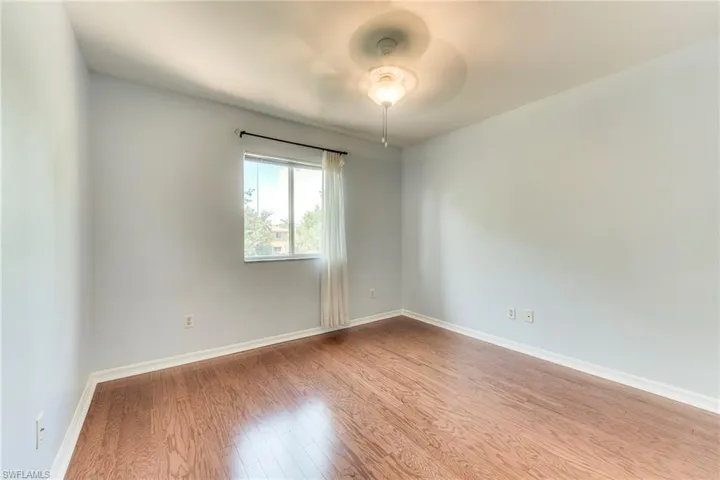 Bedroom featuring wood finished floors and ceiling fan
