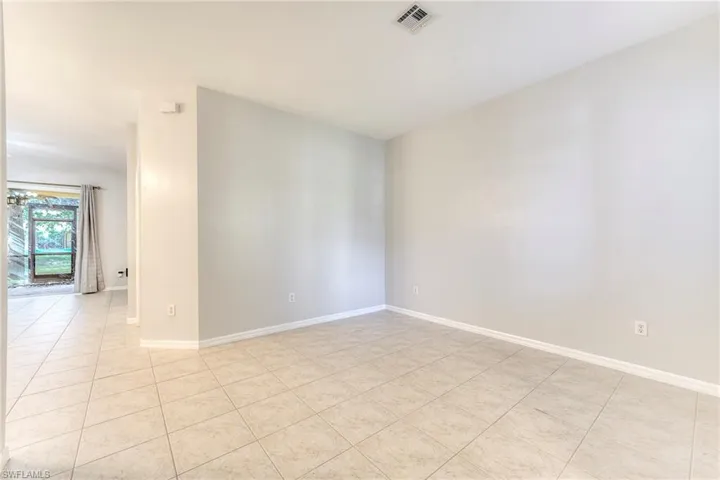 Unfurnished room with light tile patterned floors and baseboards