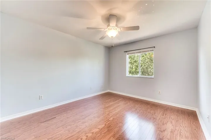 Bedroom featuring wood finished floors and a ceiling fan