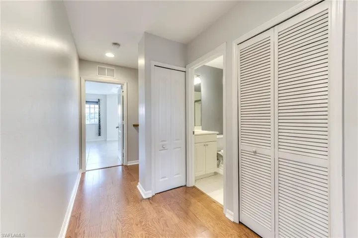 Hall featuring light wood finished floors and recessed lighting