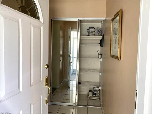 View of the coat closet with mirrored doors as you enter the home.