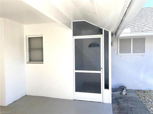 Screened in carport entry to home.