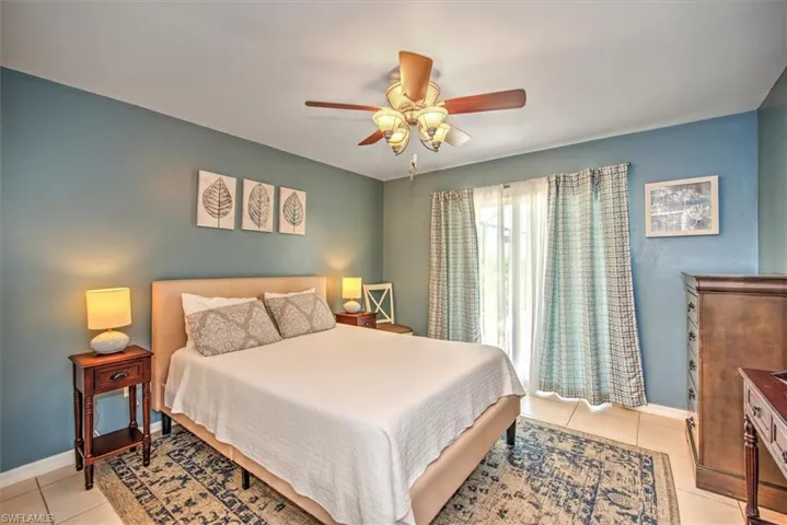Bedroom featuring ceiling fan and light tile floors
