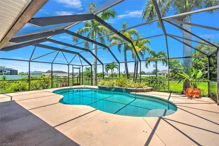 View of swimming pool featuring a patio area and a lanai