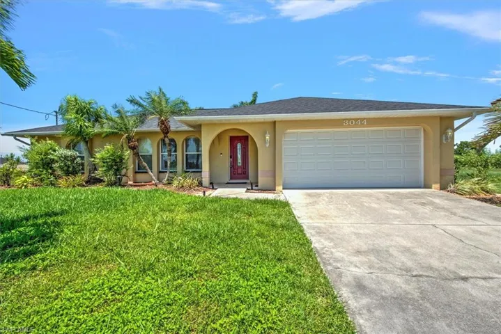 Single story home with a front lawn and a garage