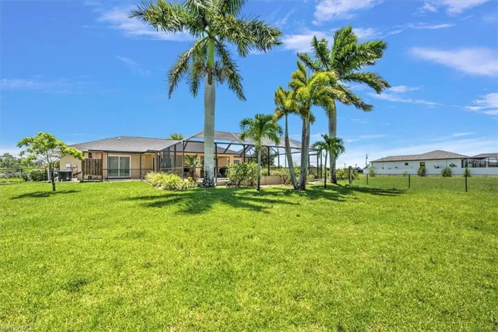 View of yard featuring glass enclosure