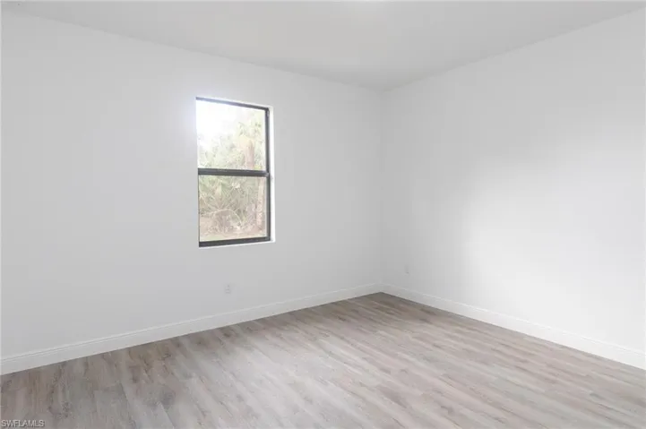 Master bedroom with light vinyl flooring.