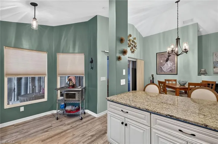 White cabinetry with dark hardware and a light-toned countertop