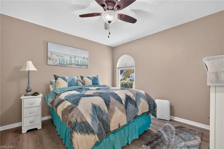 Wood-finish flooring with neutral wall tones and a ceiling fan