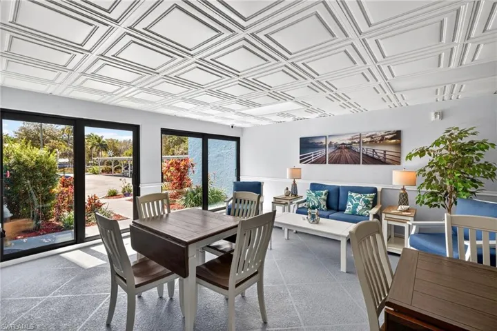 Carpeted dining space featuring an ornate ceiling