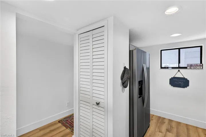 Hallway featuring light wood-style flooring and recessed lighting