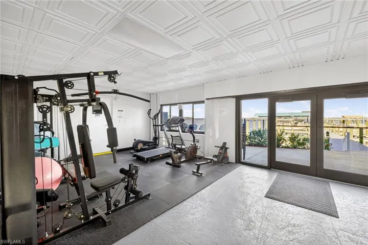 Gym with an ornate ceiling and baseboards