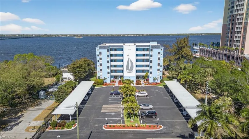 Drone / aerial view of apartment complex / building and a large body of water