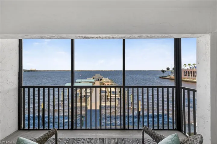 Sunroom featuring a water view