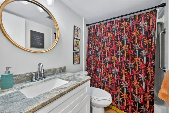 Bathroom with vanity and shower / bath combo with shower curtain