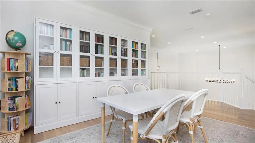 Dining area featuring light wood-type flooring, recessed lighting, a chandelier, and ornamental molding
